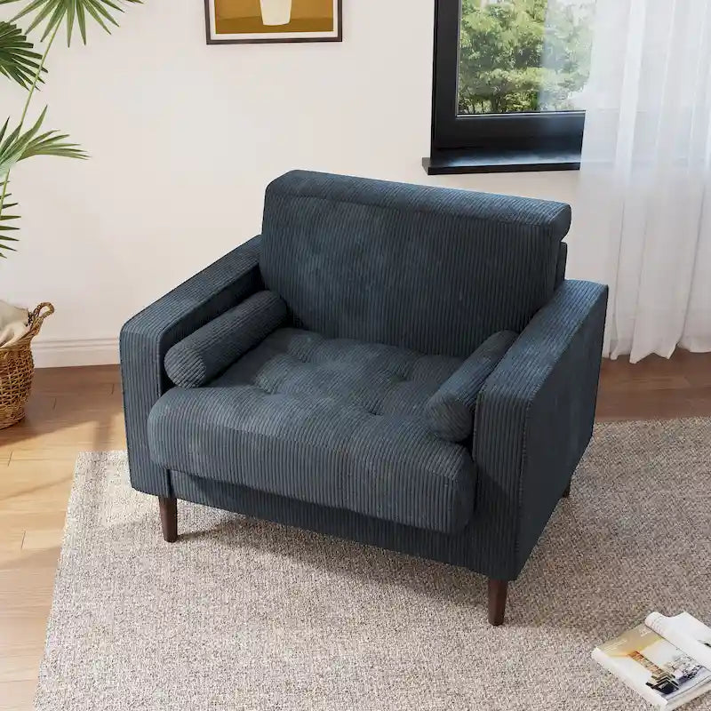 Poltrona moderna imbottita in velluto a coste con braccioli e cuscini
